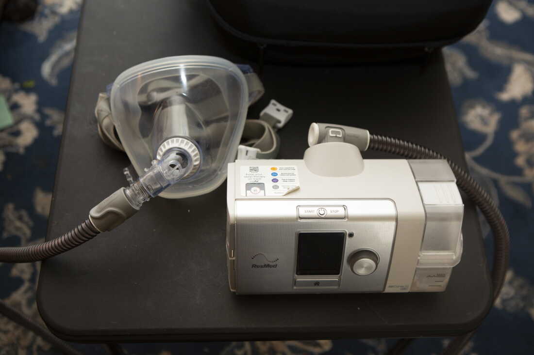 This photo shows the machine that Jeff La Marca uses to treat his obstructive sleep apnea. It consists of a plastic mask with a tube that attaches to a box-shaped machine.