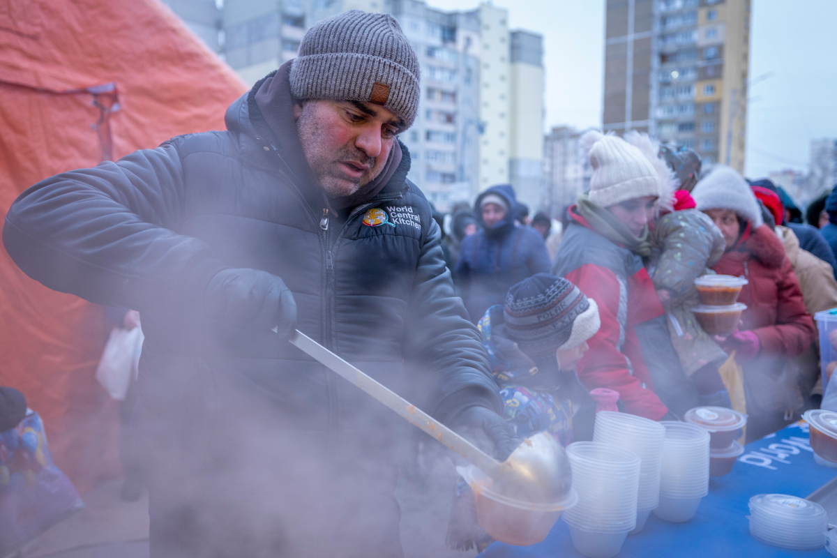 People who have no power at home following Russia's air attacks wait in line to receive free hot meals in a residential neighborhood in Kyiv on Jan. 30.
