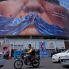 Canada hits back at the U.S. with tariffs as the countries' trade fight escalates 3 Vehicles drive past a billboard with an illustration showing the Strait of Hormuz and the sewn lips of President Trump in a square in downtown Tehran, Iran, May 2.