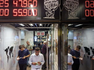 A man exchanges foreign currency at an exchange office in the Grand Bazaar in Istanbul, Turkey, on Aug. 20, 2026. The Grand Bazaar is one of the world's oldest covered markets. Today, many Turks still prefer it over banks when buying or selling gold, where they can often find better exchange rates.