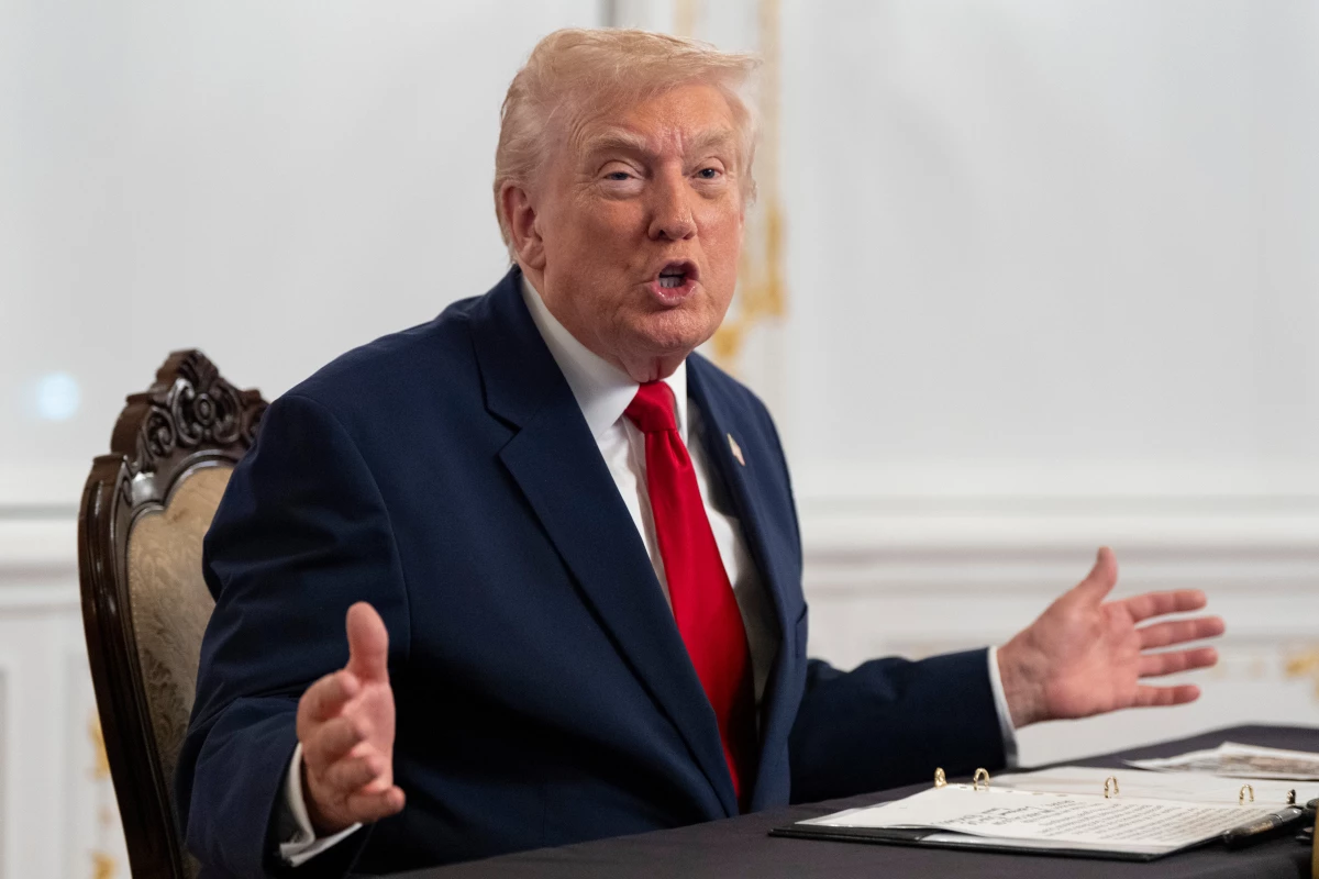 President Donald Trump speaks to reporters after speaking to troops via video from his Mar-a-Lago estate on Thanksgiving, Thursday, Nov. 27, 2025, in Palm Beach, Fla.
