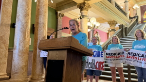 Rep. Mary Caferro, a Democrat in the Montana House, spoke at a rally in July at the Montana Capitol in Helena, criticizing the state’s expedited rollout of Medicaid work requirements. She’s among several Democrats who pushed for the state to delay implementing the rules until the Jan. 1 federal deadline.