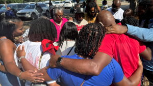 Friends and family of a deceased Delta State University student gather outside to pray after a law enforcement briefing, Wednesday, Sept. 17, 2025, in Cleveland, Miss.