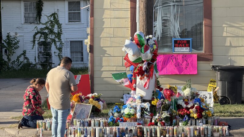 Mourners including María Guadalupe Rodríguez, kneeling, pay their respects in front of a makeshift memorial for Lorenzo Salgado Araujo, a Mexican immigrant shot and killed by immigration agents in Houston.