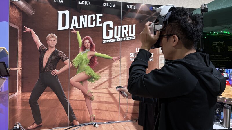 Entrepreneur David Huang tests out a VR headset while conducting demonstrations of the social dance lesson app Dance Guru at the Augmented World Expo in Long Beach Calif. June 17, 2026.