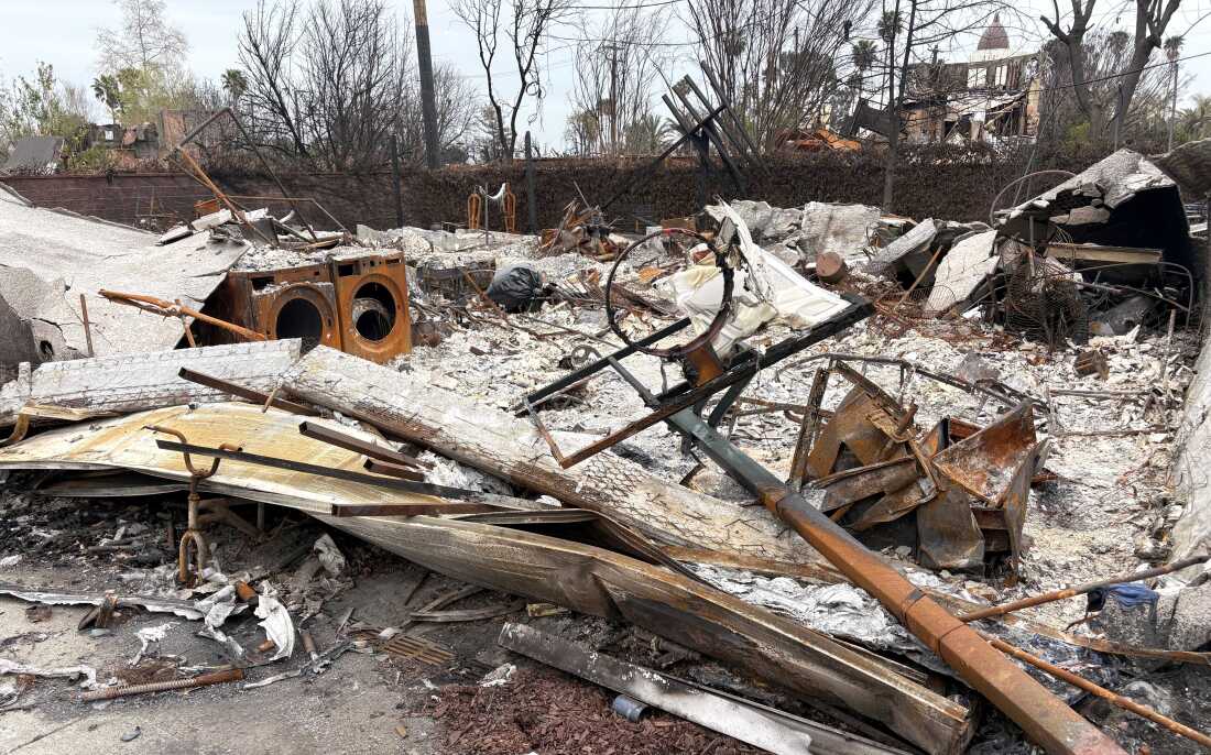 A destroyed basketball hoop and burned down garage.