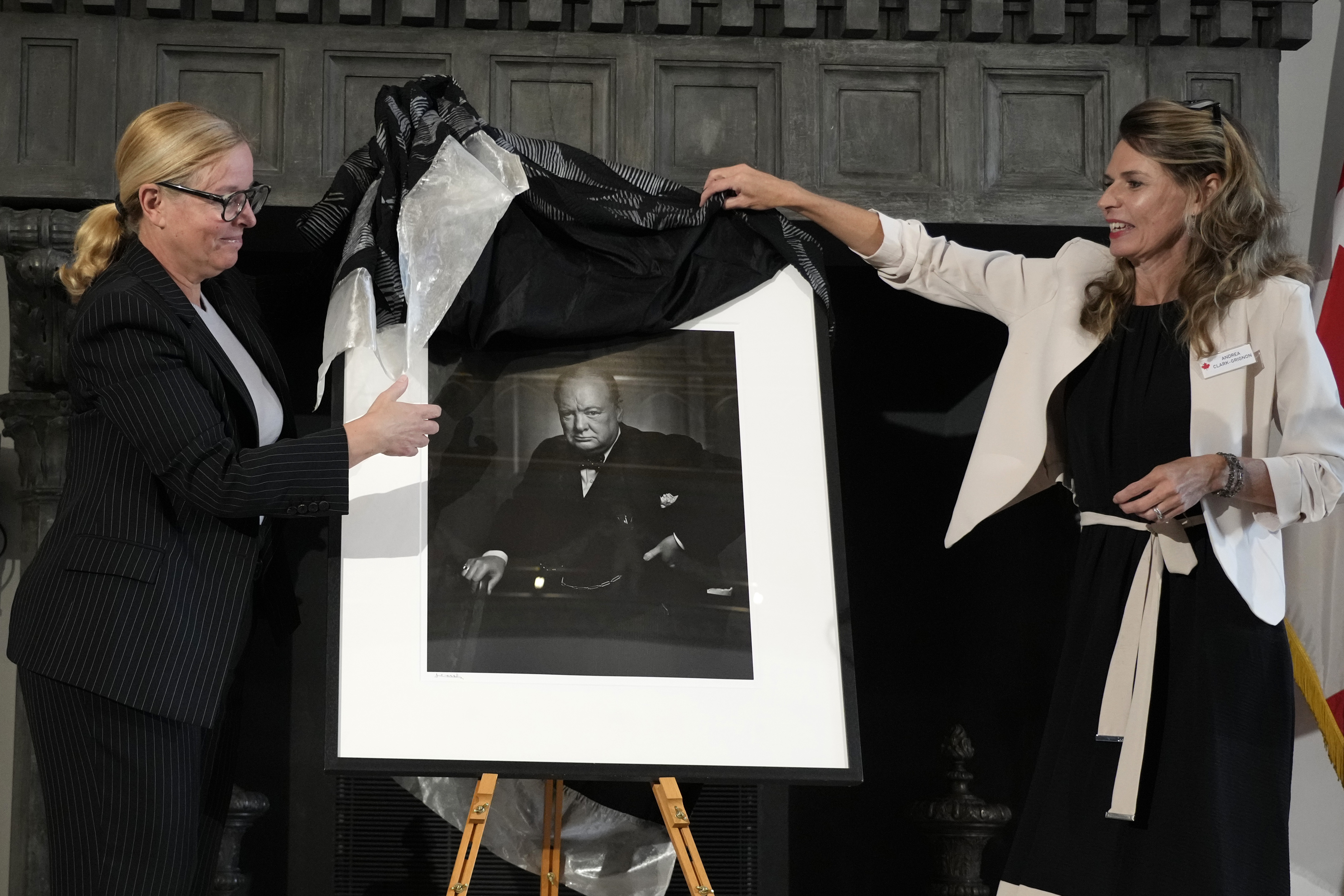 Canadian Cultural Heritage Deputy Minister, Isabelle Mondou, left, and Andrea Clark-Grignon, Head of Public Affairs, unveil a photographic portrait known as 