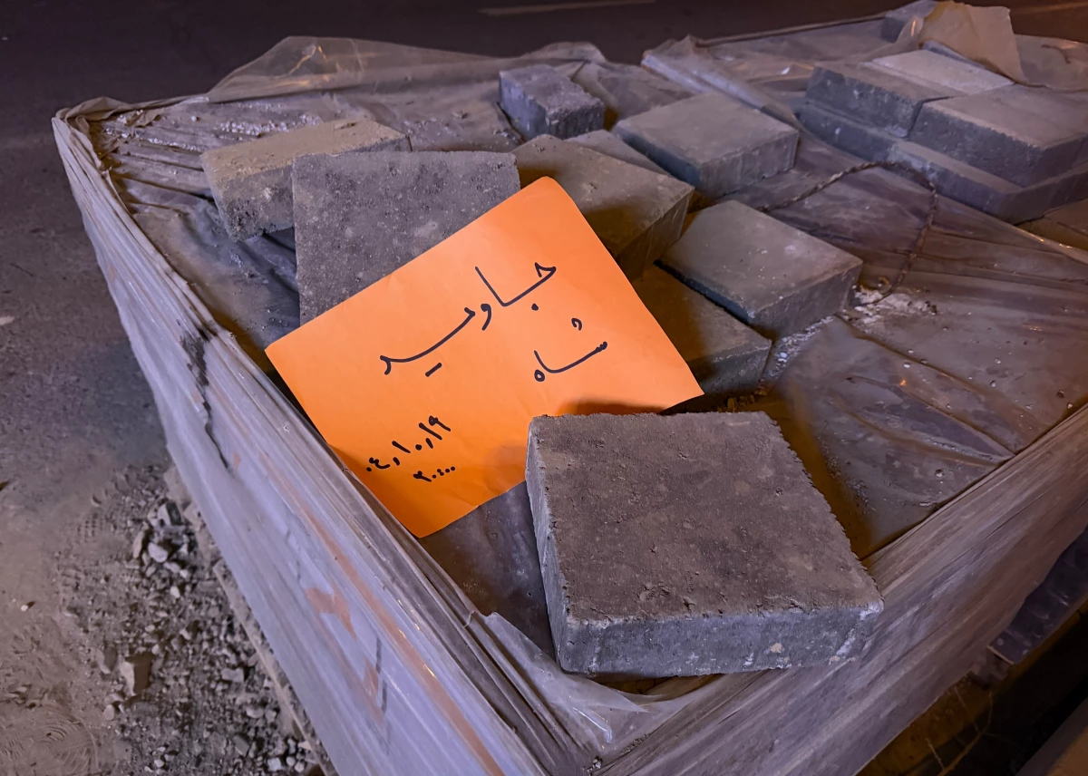 In this photo obtained by The Associated Press, a placard is placed on bricks that reads in Farsi, 'Long live the Shah,' referring to the Pahlavi dynasty that was toppled in the 1979 Islamic Revolution, during an anti-government protest in Tehran, Iran, Friday, Jan. 9, 2026.