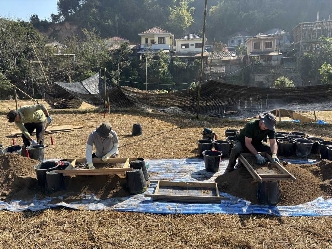 Members of a Defense POW/MIA Accounting Agency team sift dirt through screens in search of the remains of a fighter pilot whose plane crashed in northern Laos in the late 1960s, in Sam Neua, Laos, Jan. 25.