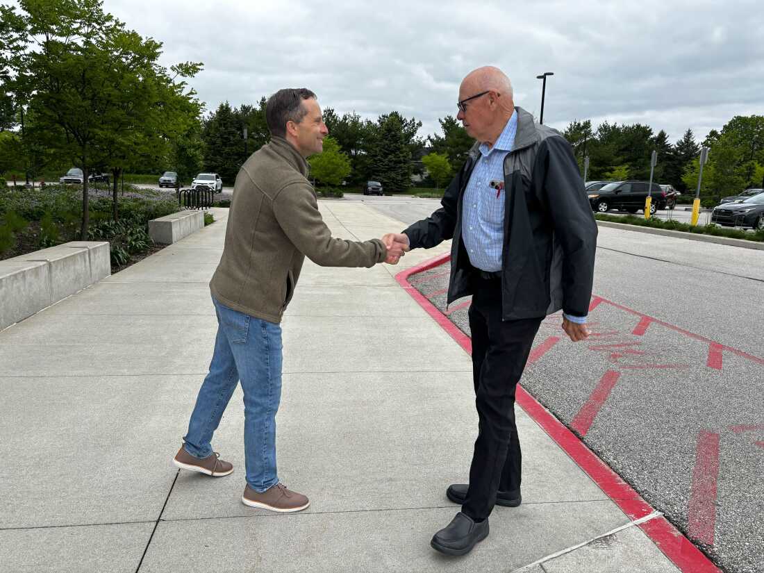 Outside a polling spot successful West Lafayette, Ind., Republican authorities Sen. Spencer Deery greets voters arriving for early voting connected April 28. Deery is simply a Republican incumbent President Trump has targeted aft he opposed the president's redistricting push successful Indiana.