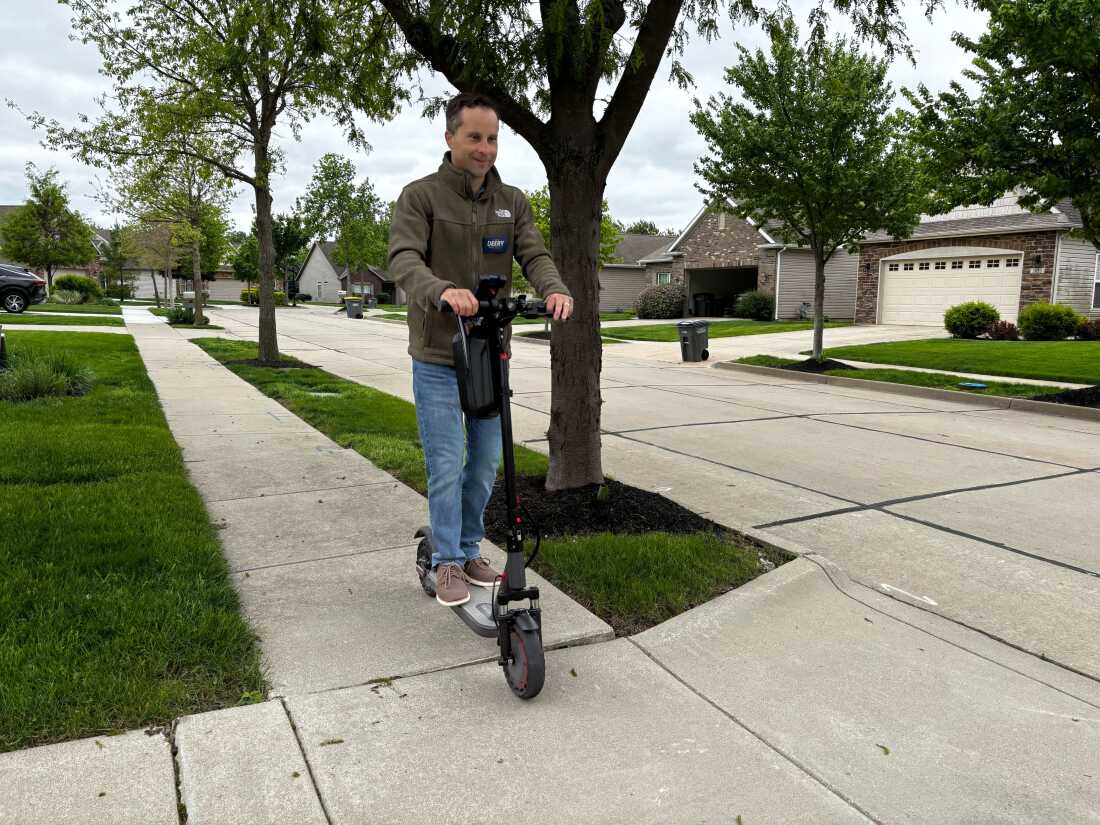 Indiana authorities Sen. Spencer Deery rides his electrical scooter to canvass neighborhoods successful his districts up connected April 28 of Indiana's superior election.