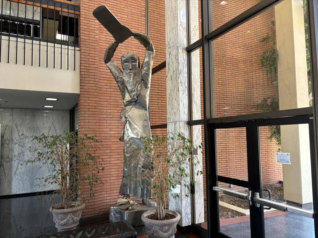 A statue of Moses smashing the tablets of the 10 Commandments is on display in the atrium of Hebrew Union College in Los Angeles. The 17-foot-tall sculpture is on loan from the Skirball Cultural Center.
