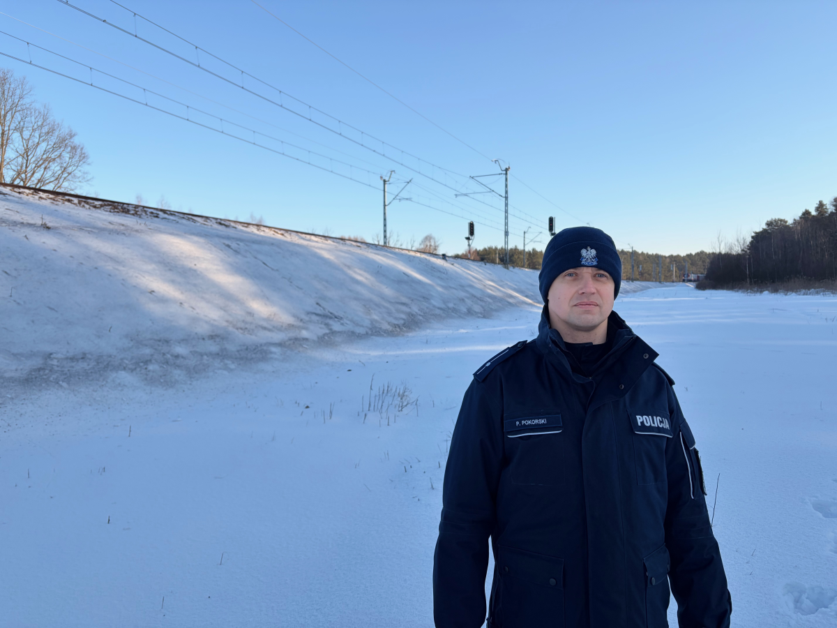 Police officer Piotr Porkoski stands in front of the portion of the Warsaw-Ukraine train line where Polish authorities say two Ukrainian perpetrators hired by Russia's government used explosives to attempt to blow up the track last November. A train conductor noticed the warped rail and called the police.