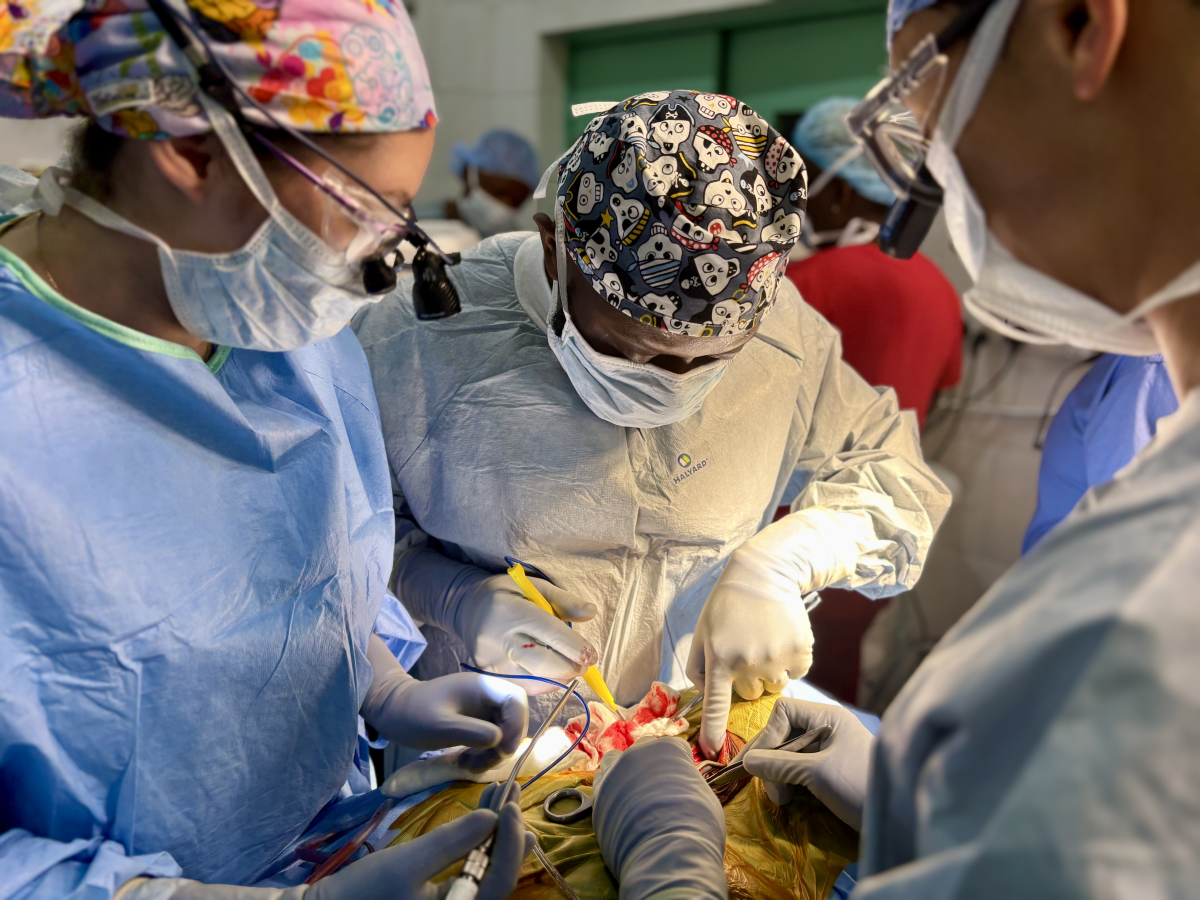 From left to right: Dr. Silvia Vaca, neurosurgeon Dr. Alieu Kamara, and Dr. Seunggu Han operate on Morie Abibu's to remove a mass is growing at the base of his skull, pressing against his spinal cord and paralyzing him from the neck down.