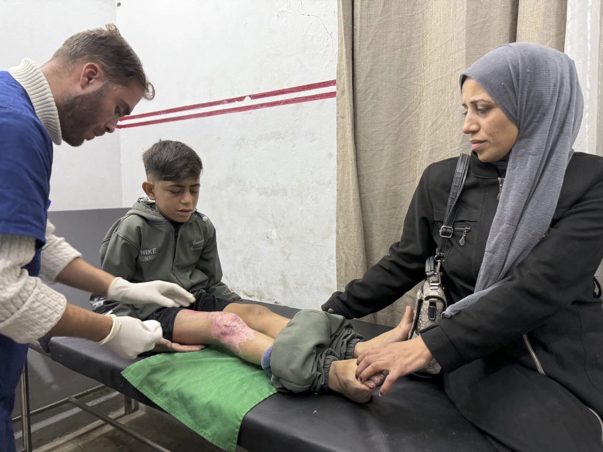 With his mother next to him, Mohammed Ibrahim, 14, receives treatment at MSF's clinic in Gaza City on Dec. 31, 2025, after being run over by a truck while he was trying to get food during a famine last summer.
