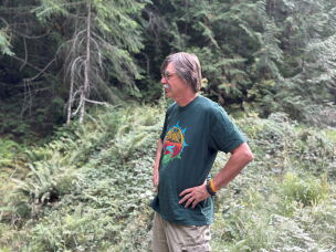 Retired U.S. Forest Forest Service firefighter Timothy Ingalsbee stands by a road in the Willamette National Forest, which was once the epicenter of the so-called Timber Wars.