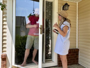 Sarah Trone Garriott canvasses for votes in Iowa. She is one of several clergy members running for Congress as Democrats this year.