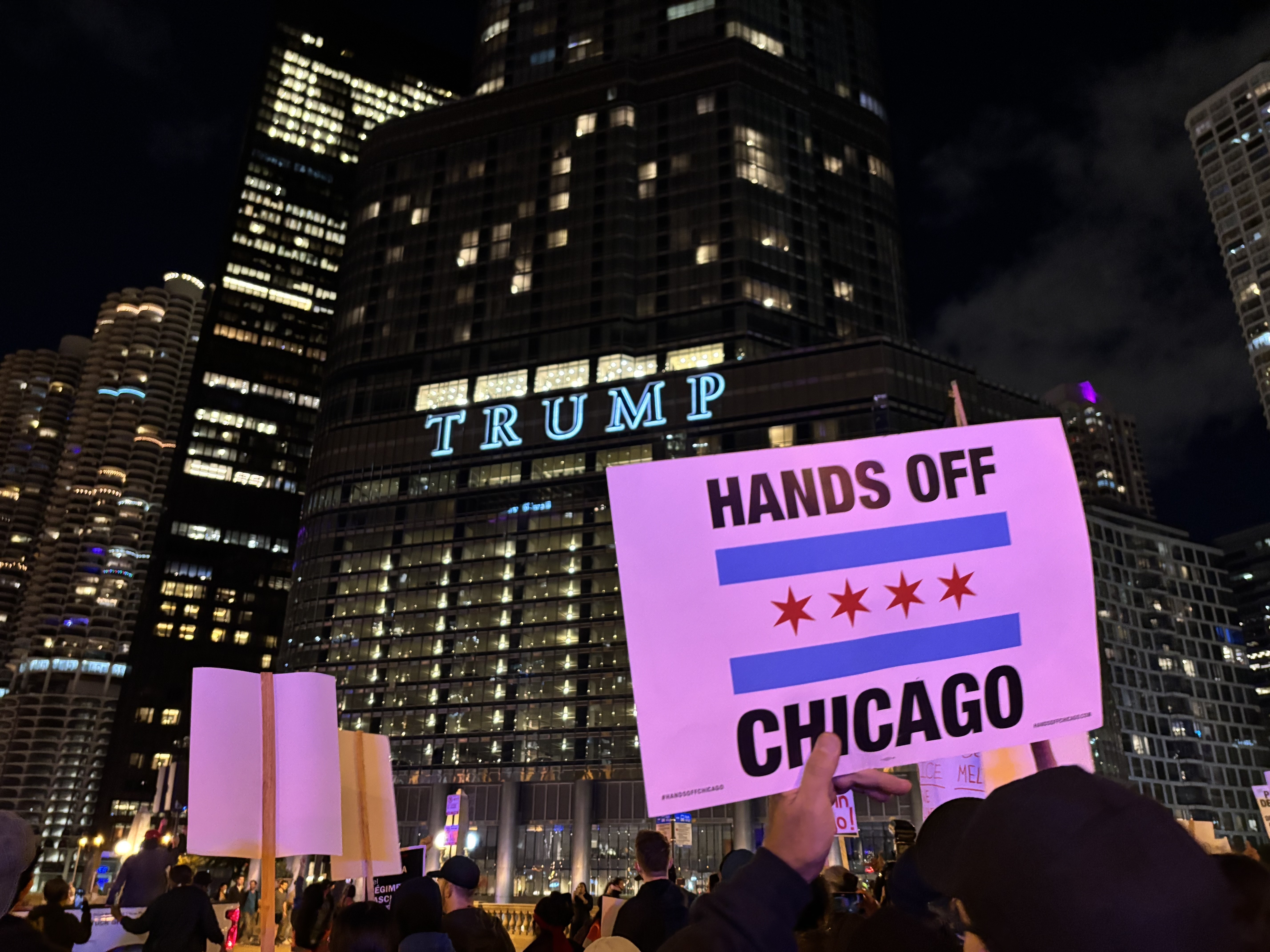 Hundreds marched in downtown Chicago on Oct. 8, protesting President's Trump deployment of National Guard troops and the presence of immigration enforcement agents in the city. (NPR)