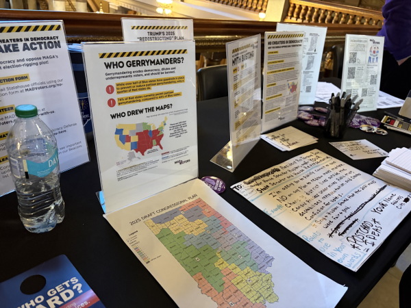 A volunteer advocacy group opposed to redistricting set up a table in the statehouse with handouts, postcards for voters to write their lawmakers and snacks and water bottles for protesters.