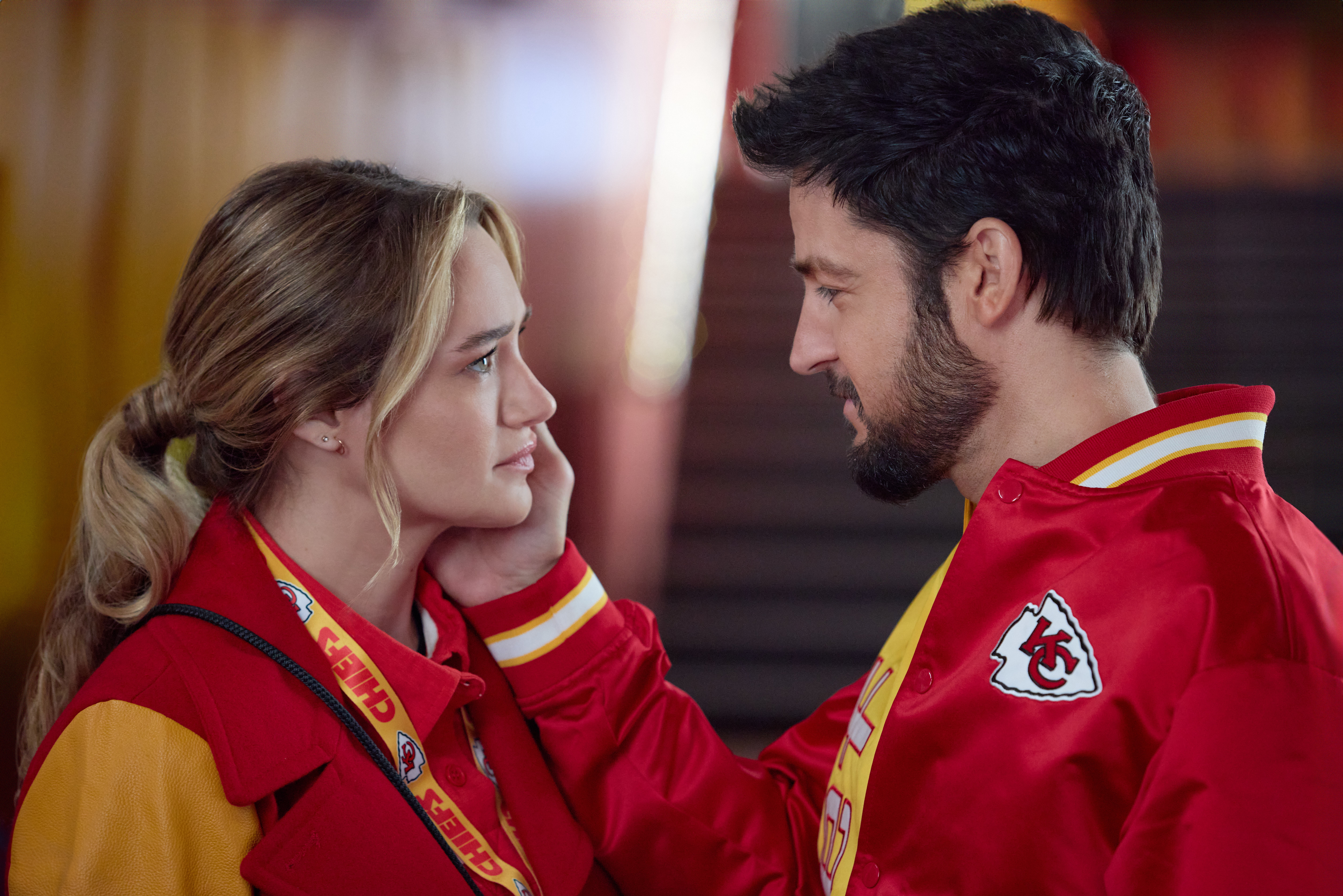 The attraction between superfan Alana (Hunter King) and Chiefs Director of Fan Engagement (Tyler Hynes) is just one of the love stories in <em>Holiday Touchdown.</em>