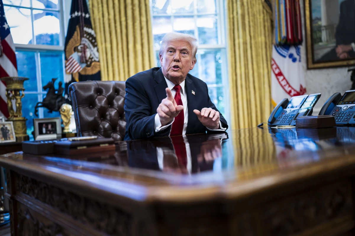 President Donald J Trump speaks to reporters about auto tariffs after signing an executive order in the Oval Office at the White House on March 26.