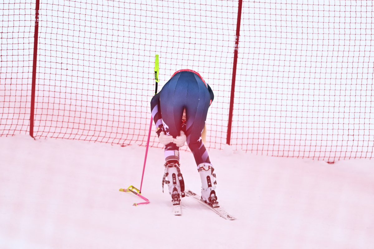 Lindsey Vonn holds the back of her left knee after crashing in the women's downhill in Crans-Montana, Switzerland on Friday. It was her final tune-up race ahead of the 2026 Winter Olympics.