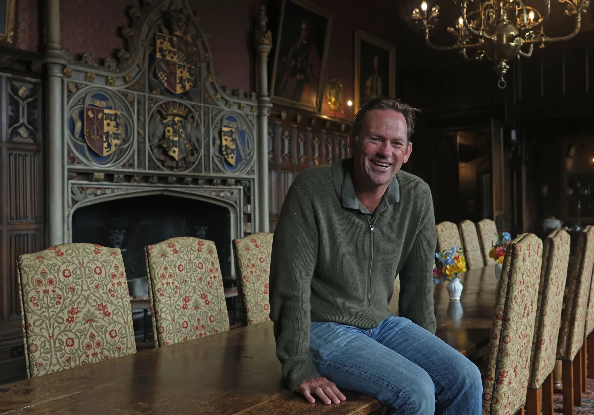 Aristocrat Charles Courtenay, 19th Earl of Devon, pictured alongside his family Coat of Arms.