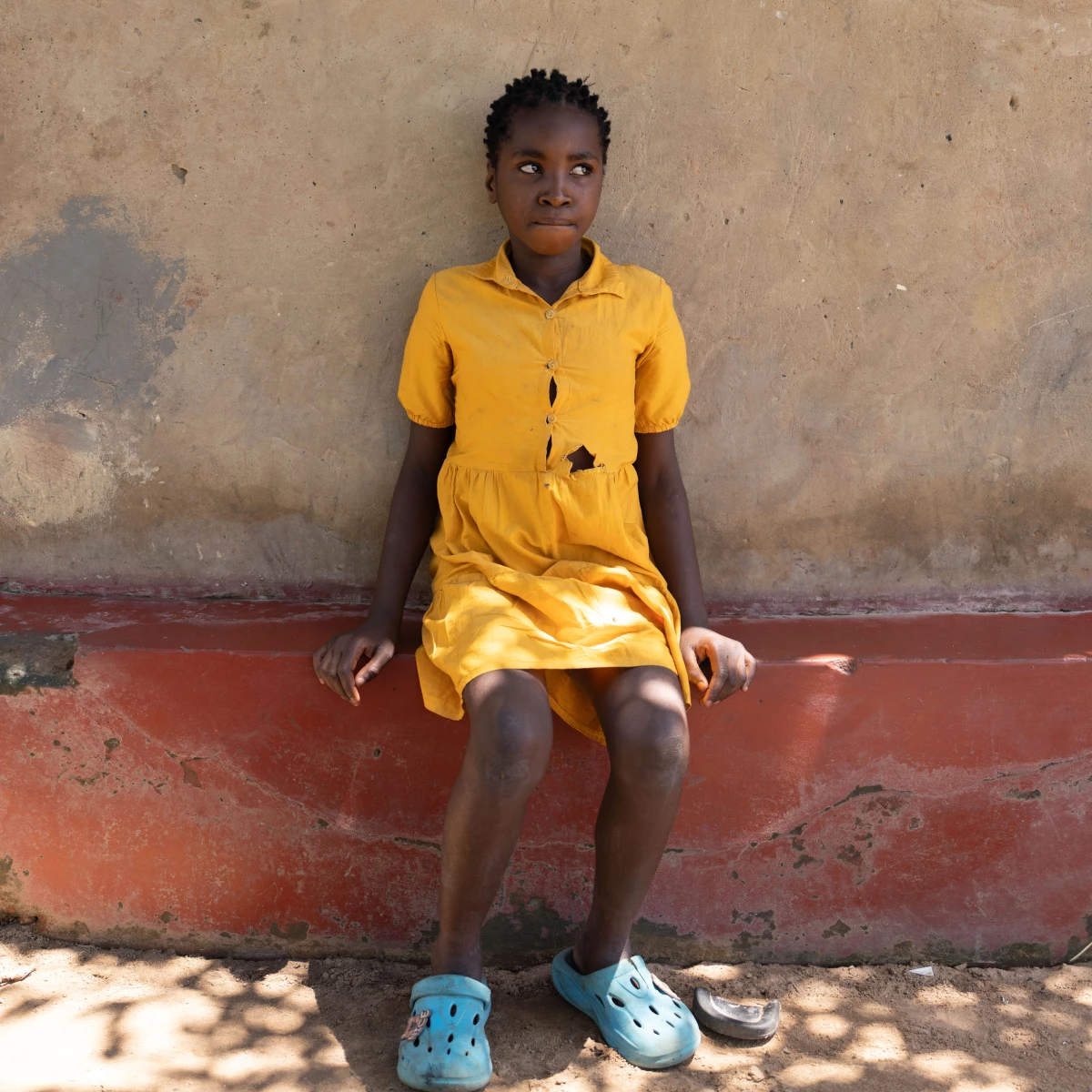 Dorcas Mwanza, 10, took the last of her HIV medications eight days ago. She's developed a fever and chills, among the first symptoms people experience when they go off HIV treatment.