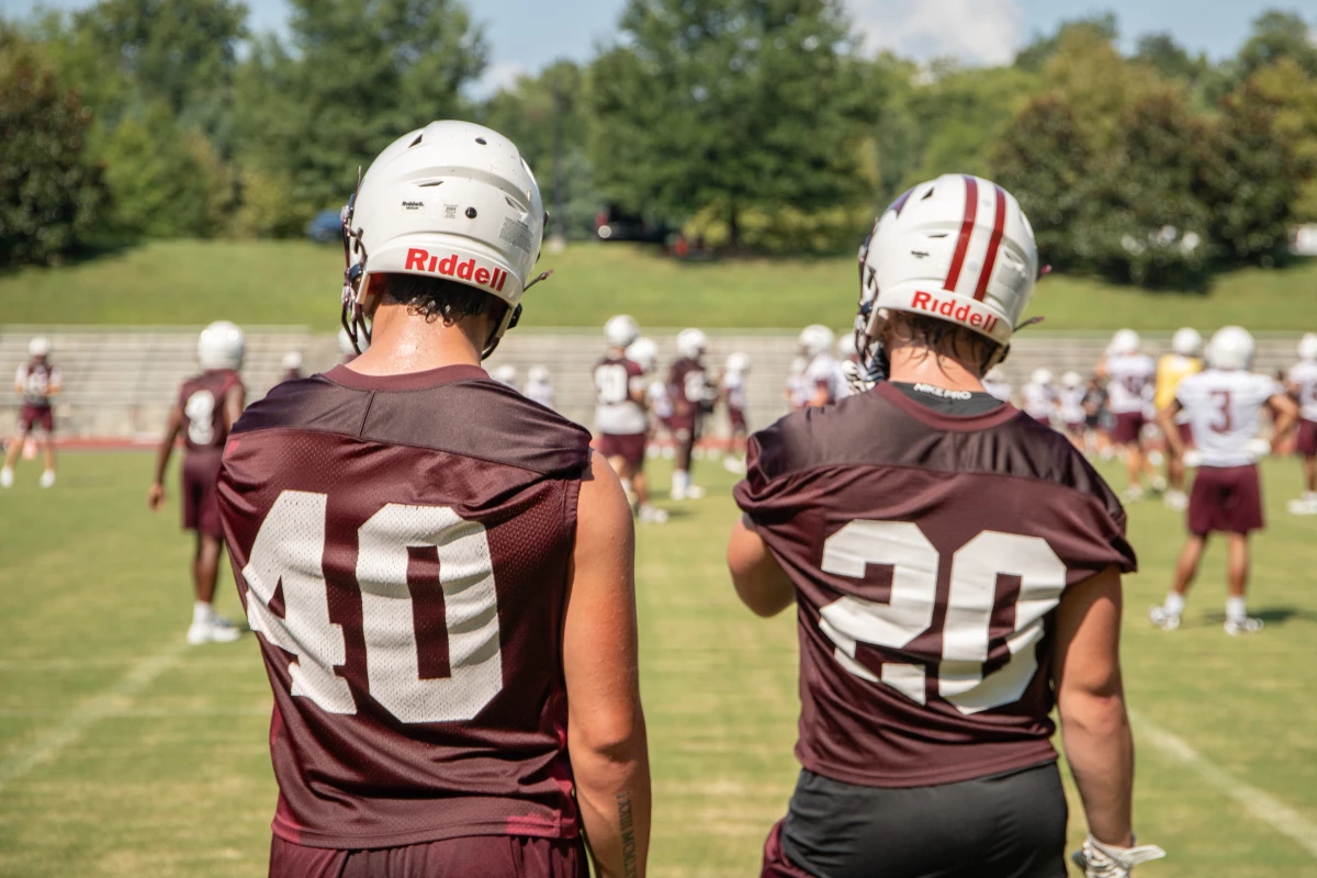 Roanoke College linebackers Connor Cox (40) and Austin Fisher (20) watch from the sidelines. This is Roanoke's first season playing varsity football since 1942.