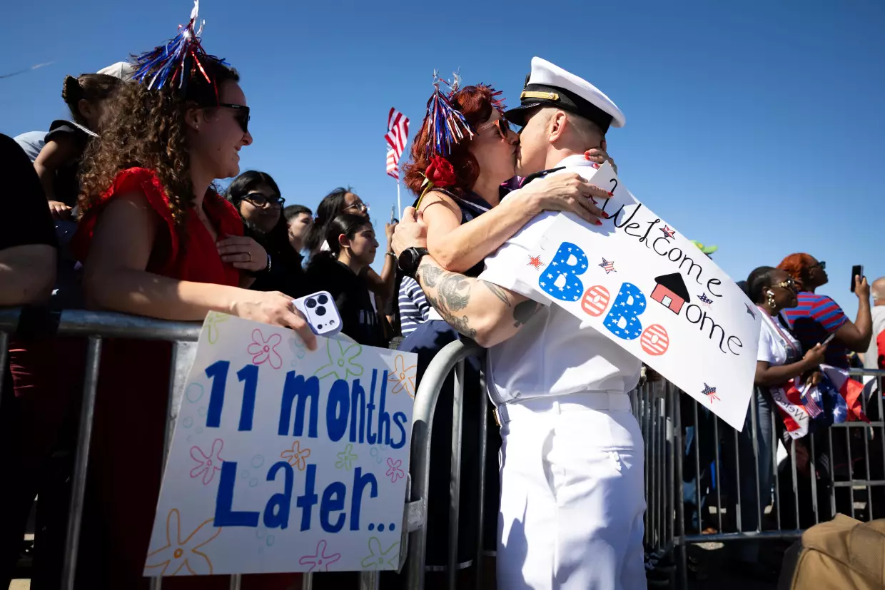 Juan Caceres kisses Heidi Eckstein after disembarking from the aircraft carrier USS Gerald R. Ford at Naval Station Norfolk on May 16 in Norfolk, Va.