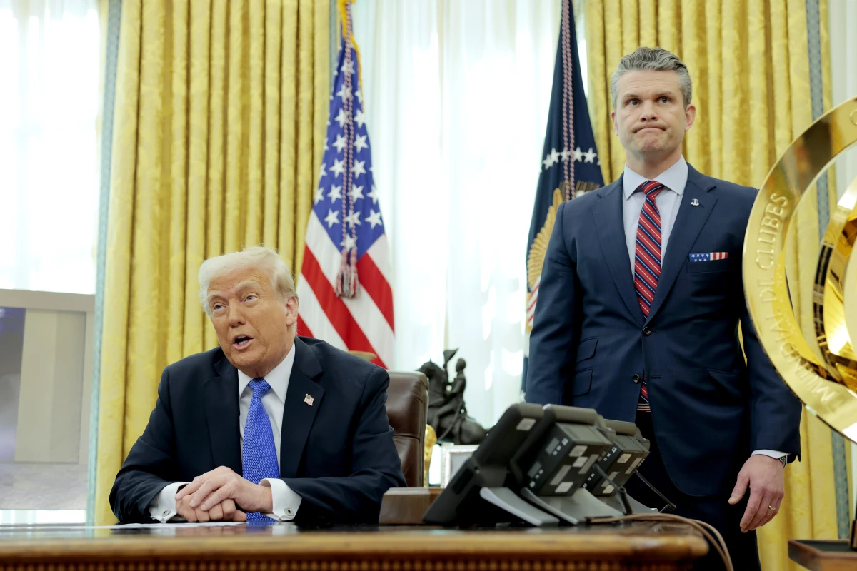 President Trump speaks alongside Secretary of Defense Pete Hegseth in the Oval Office on March 21. Days earlier, Hegseth shared details about overseas war plans in a group chat on Signal, an encrypted, open-source messaging app, according to The Atlantic.