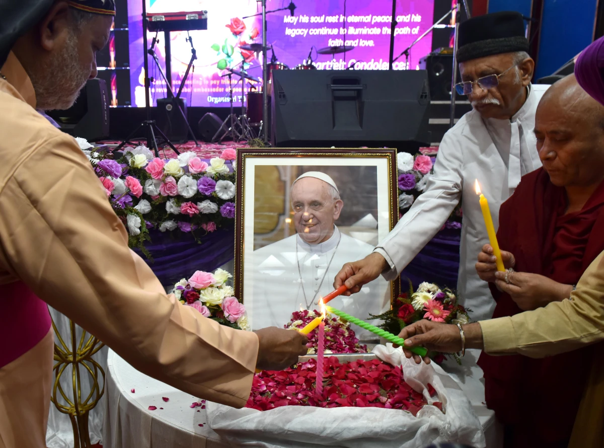 People attend an interfaith memorial meeting to mourn the death of Pope Francis in New Delhi, India, on Monday.