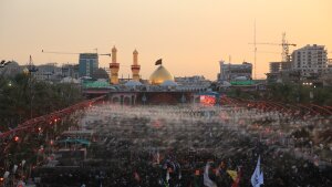 Large crowds of pilgrims fill the area between the two holy shrines in Karbala at sunset