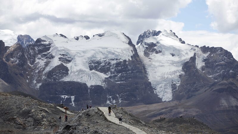 Tourists walk in front of the Tuco glacier in Huascaran National Park during a tour called the "Route of climate change" in Huaraz, Peru, Aug. 12, 2016.