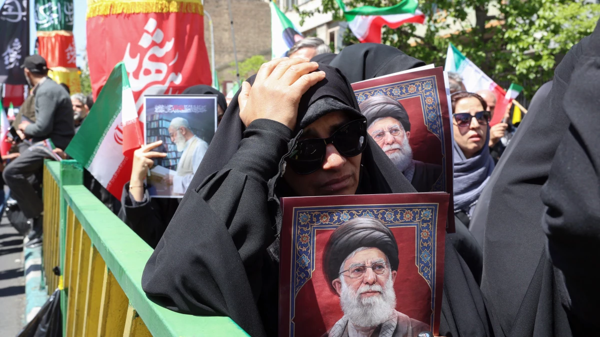 Iranians hold portraits of slain Iran's supreme leader Ayatollah Ali Khamenei during a rally to commemorate his death in Tehran on April 9, 2026. Thousands of Iranians paid tribute to the late supreme leader Ali Khamenei, who ruled the country for nearly four decades until his killing in US-Israeli strikes at the start of the Middle East war.