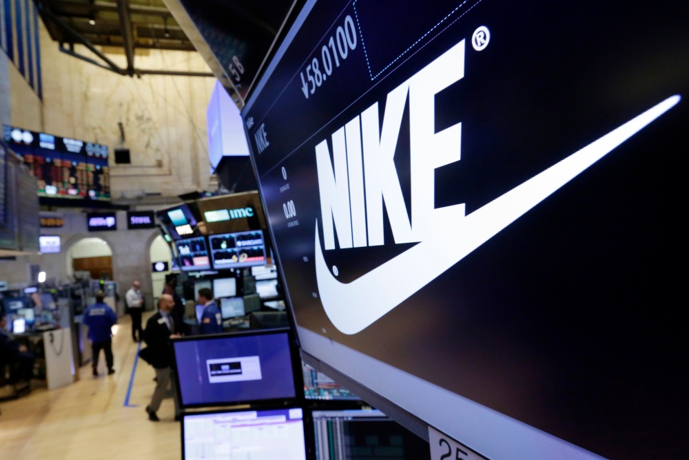 The Nike logo appears above the post where it trades on the floor of the New York Stock Exchange, March 22, 2017. (AP)