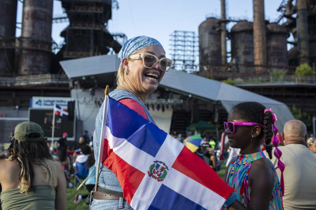 Maritza Ortiz dances with a friend’s daughter, Island Gardner, 6, at the Dominican Festival, at the Levitt Pavilion at SteelStacks, in Bethlehem, Pa.