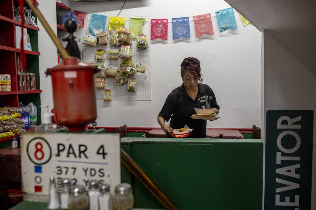 Beti Rosales, 47, cleans up a table at her family’s La Placita Mexican restaurant, a 30-year-old deli, grocery and cafe, in Allentown, Pa. Beti said that their community has lost faith in the political system, expressing frustration over what they see as a lack of consistent engagement from elected officials. "Politicians show up only around election time," Beti said.