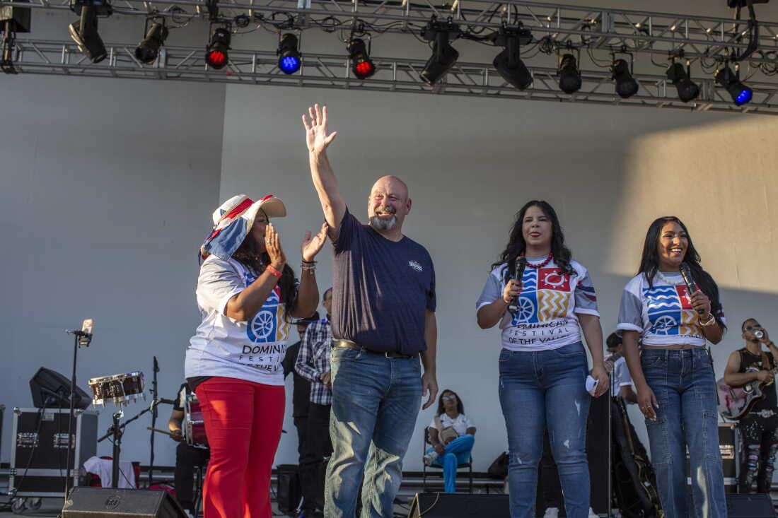 Bob Brooks, former firefighter and Lehigh Valley's Democratic candidate for Congress, greets the audience at The Dominican Festival, at the Levitt Pavilion at SteelStacks, in Bethlehem, Pa.