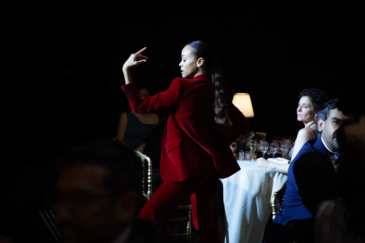 In a musical and dance number, lawyer Rita Moro Castro (Zoe Saldaña) calls out the corruption of business and political leaders.