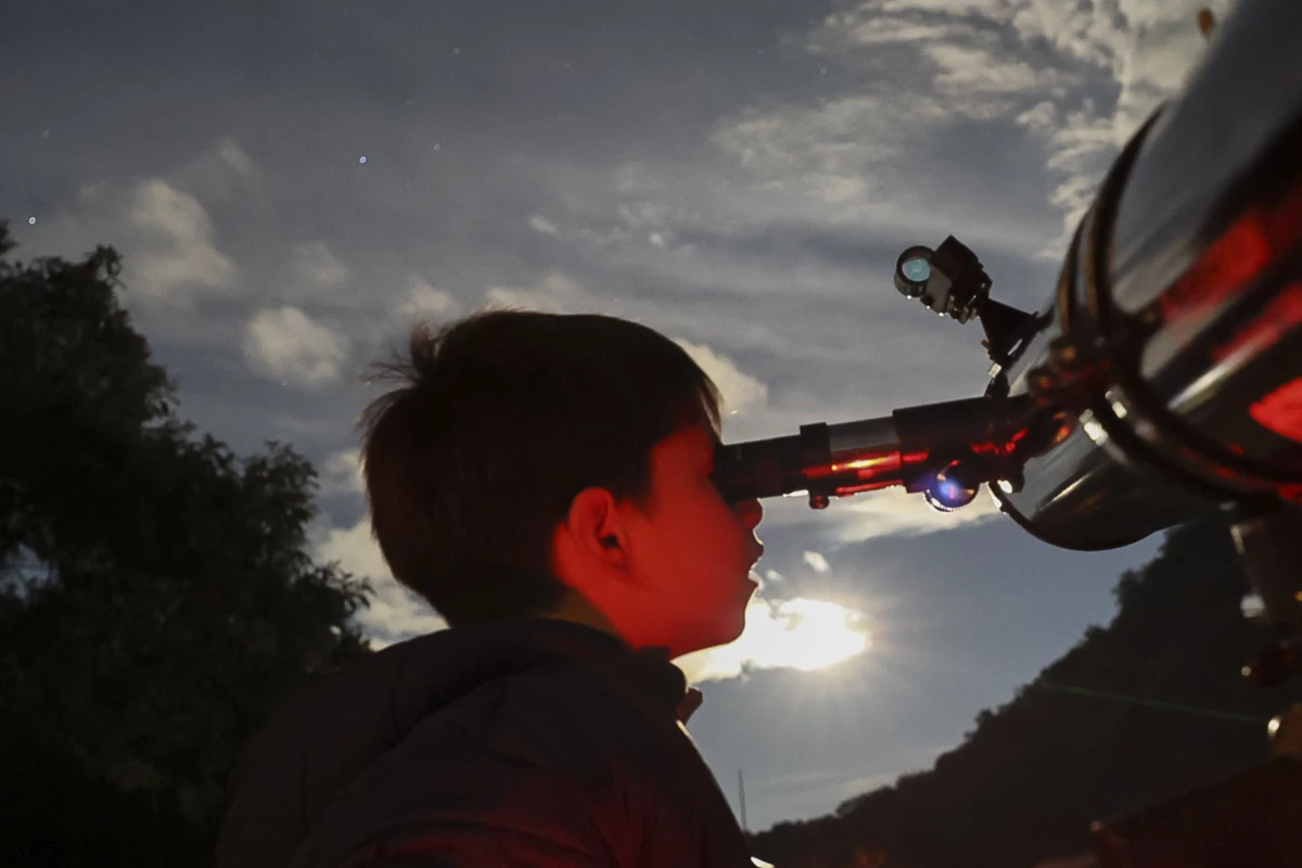 A youth looks through a telescope during a stargazing and comet-watching gathering at Joya-La Barreta Ecological Park in Queretaro, Mexico, on Oct. 19, 2024.