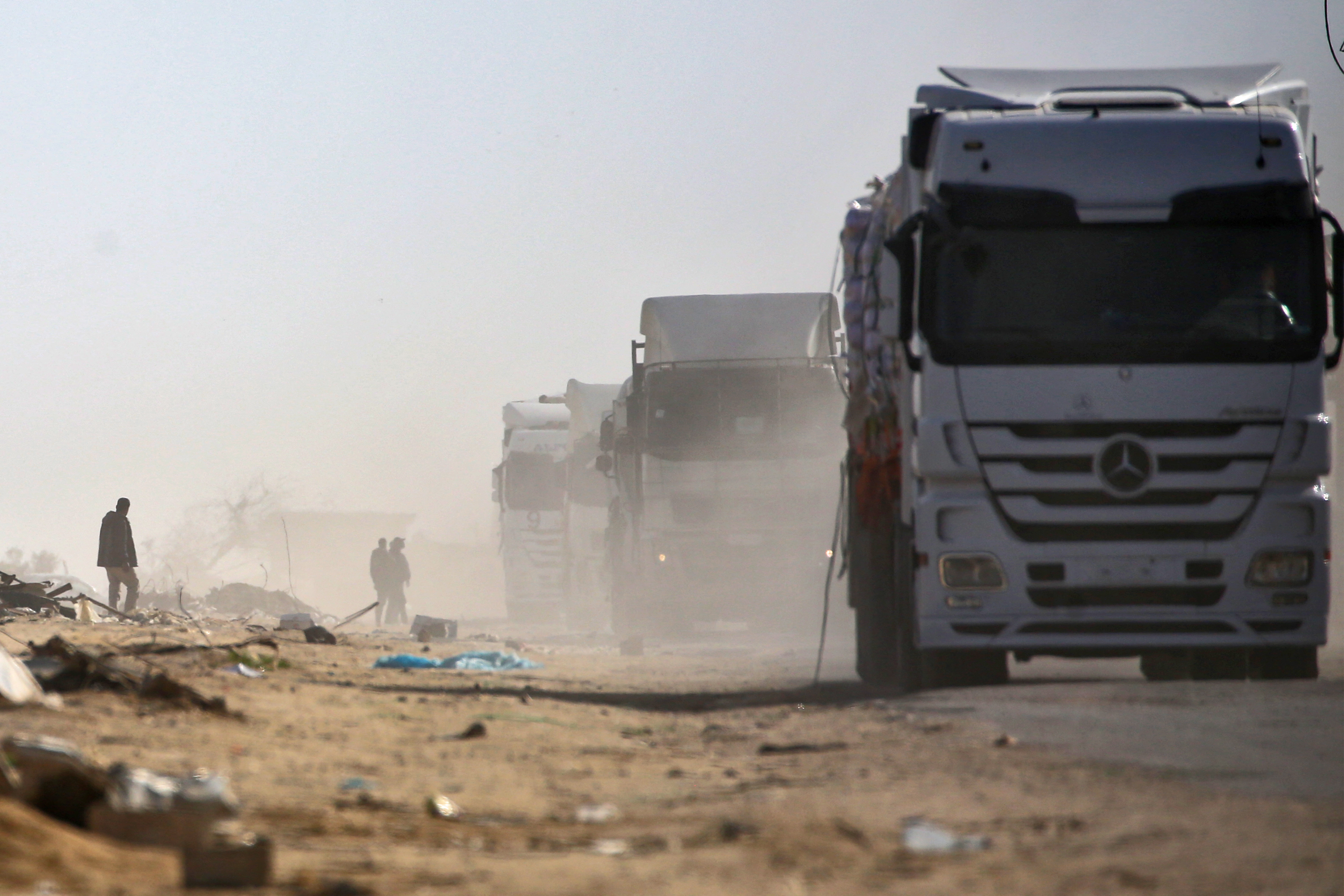 Trucks loaded with humanitarian aid drive through Rafah in the southern Gaza Strip after entering from the Kerem Shalom crossing on February 18, 2025.