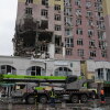 Rescuers work on the scene of a building damaged by a Russian attack in Kyiv, Ukraine, Saturday, Dec. 27, 2025.