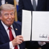 In this file photo from July 2026, President Trump shows off an executive order he signed in the Oval Office of the White House.