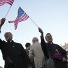 Clerics wave US flags during the speech of the newly elected Pope Leo XIV at the Vatican, Thursday, May 8.
