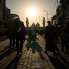 People walk toward the Kadhimiya Shrine at sunset in the Shia neighborhood in Baghdad, Tuesday.