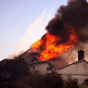 A roof engulfed in flames is seen during the Norte Fire on Friday, Oct. 16, 2026, in San Juan Capistrano, Calif.