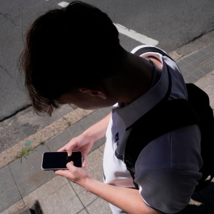 FILE - A teenage boy uses his phone in Sydney, Nov. 8, 2024.