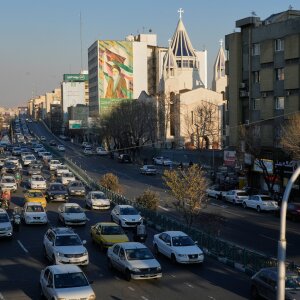Vehicles drive past the Saint Sarkis church and a painting of the late Iranian revolutionary founder Ayatollah Khomeini in downtown Tehran, Iran, Wednesday, Feb. 25, 2026.