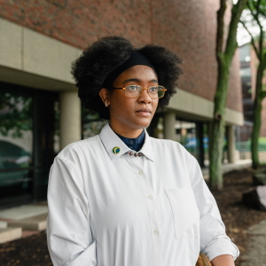 Netia McCray stands outside the Museum of Science, where she runs a STEM educational program for teens, in Boston, Mass. McCray, who developed long COVID near the beginning of the pandemic, was volunteering on a federal advisory committee on the disease before it was terminated. 